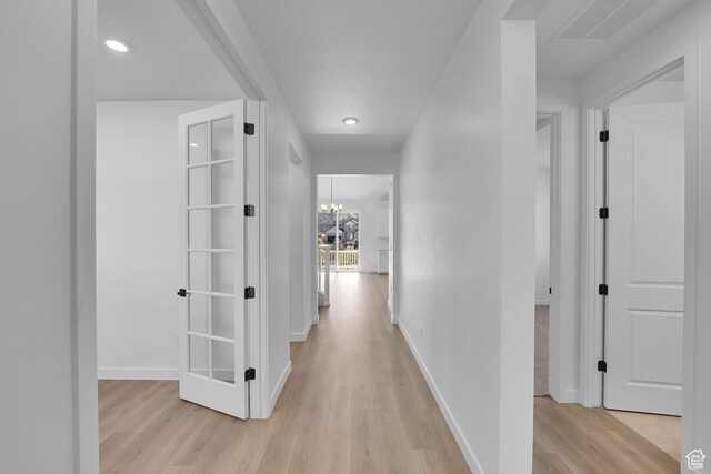 1089 S 3170 E Unit 205, Spanish Fork, UT 84660 - corridor featuring light wood finished floors, recessed lighting, and a chandelier