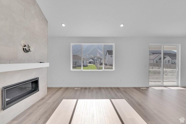 1089 S 3170 E Unit 205, Spanish Fork, UT 84660 - unfurnished living room with wood finished floors, plenty of natural light, a large fireplace, and recessed lighting