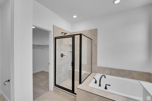 1089 S 3170 E Unit 205, Spanish Fork, UT 84660 - bathroom featuring a shower stall, a garden tub, a walk in closet, recessed lighting, and tile patterned flooring