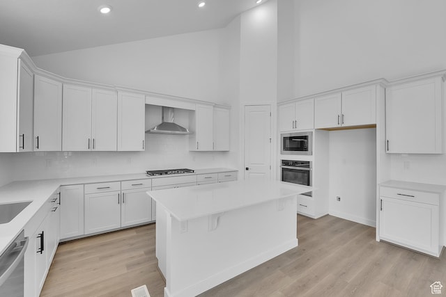 1089 S 3170 E Unit 205, Spanish Fork, UT 84660 - kitchen featuring stainless steel appliances, wall chimney exhaust hood, high vaulted ceiling, white cabinets, and recessed lighting