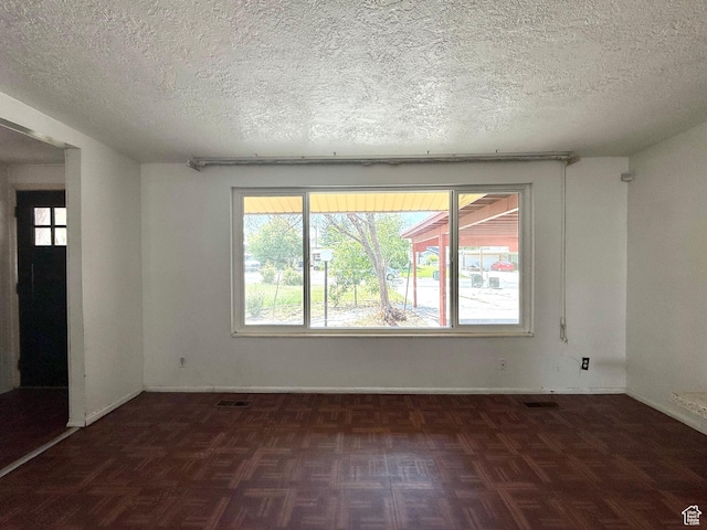4203 S 4900 W, West Valley City, UT 84120 - empty room featuring a textured ceiling, plenty of natural light, and baseboards