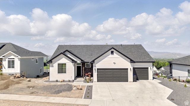 653 S 1140 E, Smithfield, UT 84335 - view of front of property with an attached garage, board and batten siding, driveway, and roof with shingles