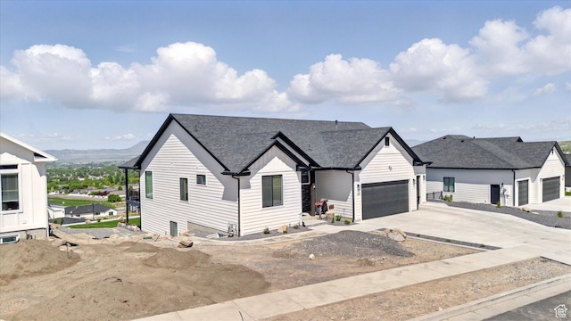 653 S 1140 E, Smithfield, UT 84335 - view of front of house with driveway, a garage, and roof with shingles