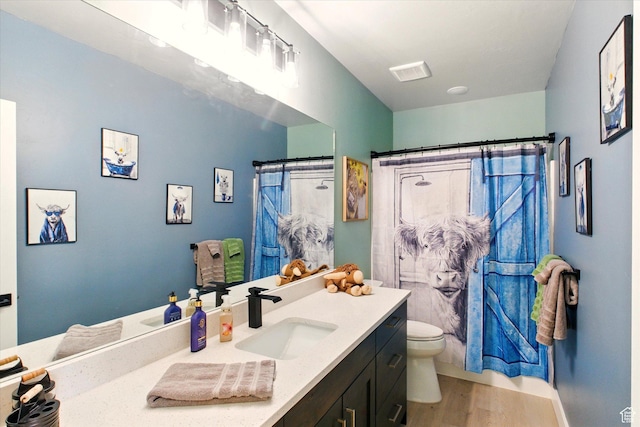 653 S 1140 E, Smithfield, UT 84335 - bathroom with vanity, toilet, wood finished floors, and curtained shower