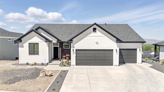 653 S 1140 E, Smithfield, UT 84335 - modern farmhouse featuring board and batten siding, a garage, roof with shingles, and driveway