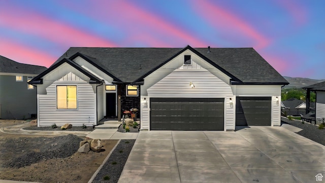 653 S 1140 E, Smithfield, UT 84335 - modern farmhouse with a garage, concrete driveway, board and batten siding, and roof with shingles