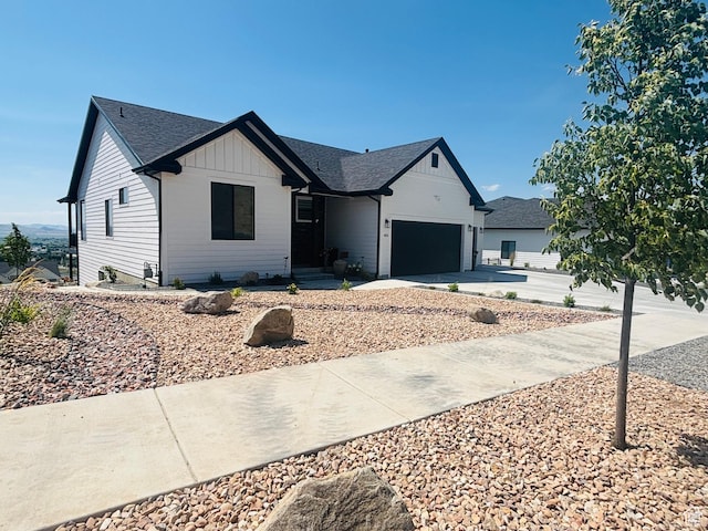 653 S 1140 E, Smithfield, UT 84335 - modern farmhouse featuring a garage, concrete driveway, board and batten siding, and a shingled roof