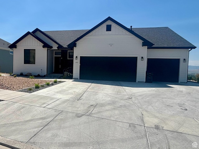 653 S 1140 E, Smithfield, UT 84335 - modern farmhouse style home featuring a garage, driveway, board and batten siding, and a shingled roof