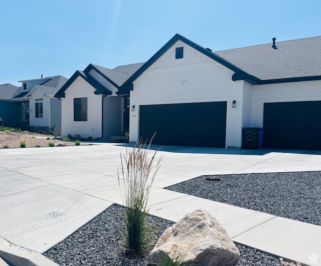 653 S 1140 E, Smithfield, UT 84335 - modern farmhouse style home with board and batten siding, a garage, and driveway