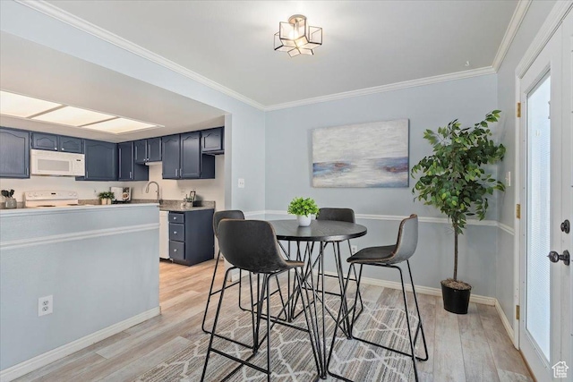 719 N 400 W, Orem, UT 84057 - dining space featuring light wood-style floors, crown molding, and baseboards