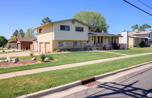 2263 W 4400 S, Roy, UT 84067 - split level home featuring brick siding, a porch, a garage, concrete driveway, and a front lawn