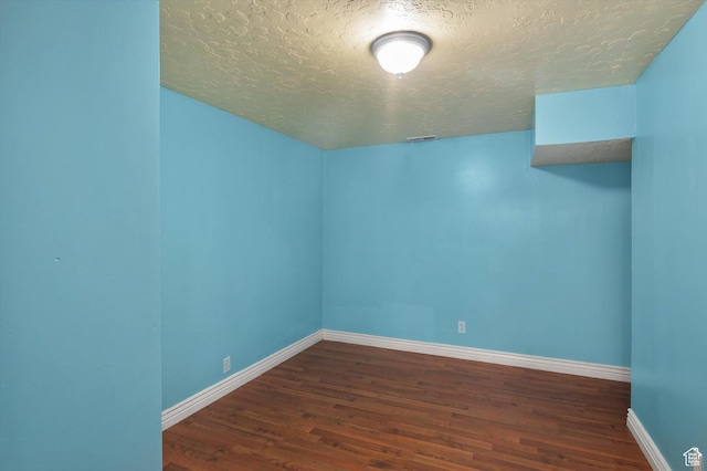 2263 W 4400 S, Roy, UT 84067 - bonus room with a textured ceiling, dark wood-type flooring, and baseboards