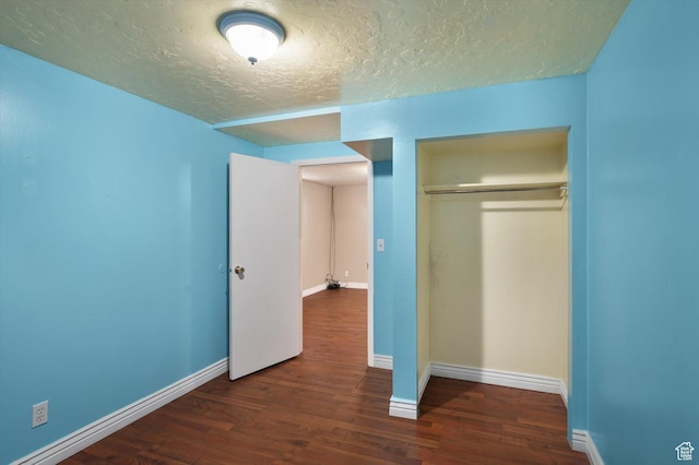 2263 W 4400 S, Roy, UT 84067 - unfurnished bedroom featuring wood finished floors, a textured ceiling, a closet, and baseboards