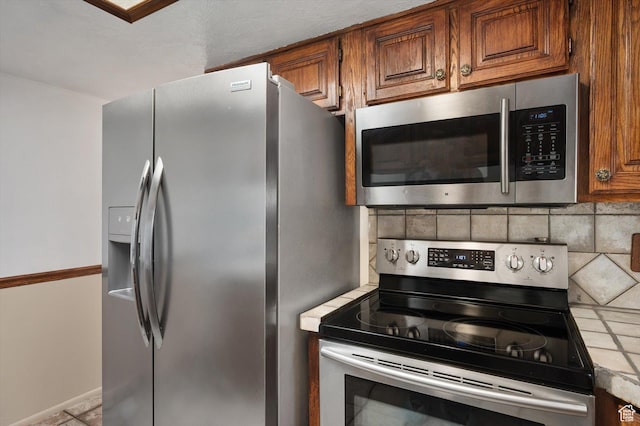 2263 W 4400 S, Roy, UT 84067 - kitchen featuring appliances with stainless steel finishes, brown cabinets, tasteful backsplash, and light countertops