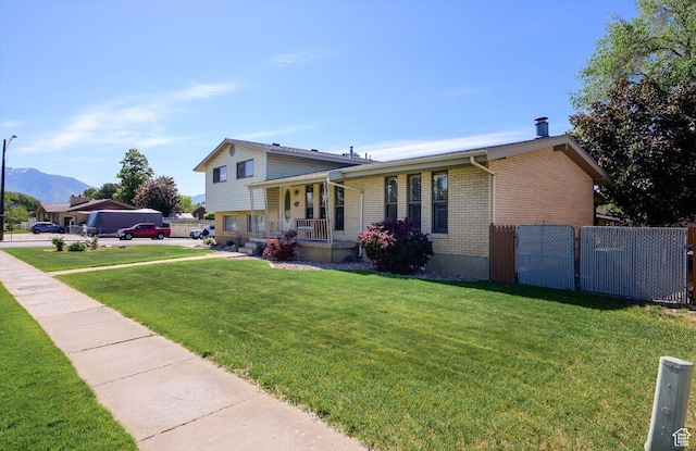 2263 W 4400 S, Roy, UT 84067 - split level home featuring brick siding, covered porch, and a mountain view