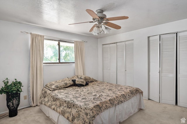 2263 W 4400 S, Roy, UT 84067 - bedroom featuring light carpet, multiple closets, and a ceiling fan