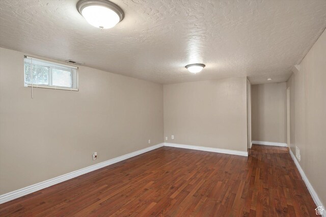 2263 W 4400 S, Roy, UT 84067 - below grade area featuring a textured ceiling, dark wood-style flooring, and baseboards