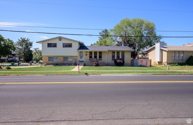 2263 W 4400 S, Roy, UT 84067 - view of front of property with a front lawn, covered porch, and brick siding