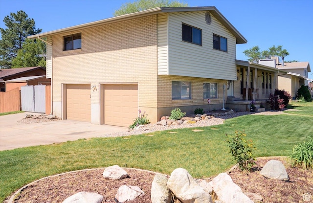 2263 W 4400 S, Roy, UT 84067 - view of front of home with an attached garage, driveway, brick siding, and covered porch