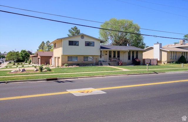 2263 W 4400 S, Roy, UT 84067 - split level home featuring a front yard, a porch, and brick siding