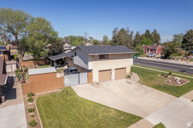 2263 W 4400 S, Roy, UT 84067 - view of front facade with a gate, concrete driveway, an attached garage, and brick siding