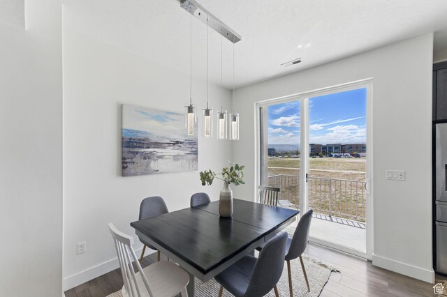 11398 Lake Run Rd, South Jordan, UT 84095 - dining area featuring baseboards and wood finished floors