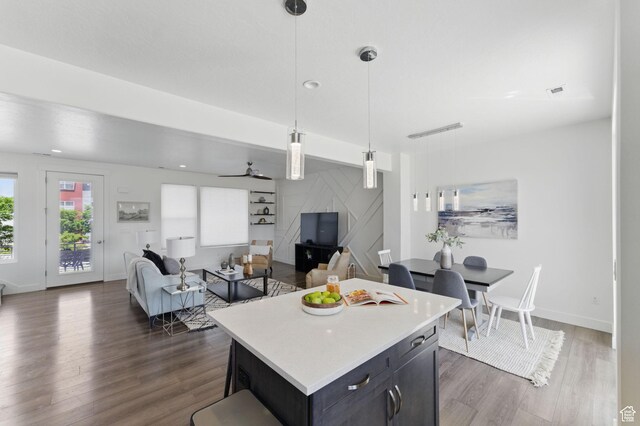 11398 Lake Run Rd, South Jordan, UT 84095 - kitchen featuring dark wood-type flooring, light countertops, decorative light fixtures, and a kitchen island