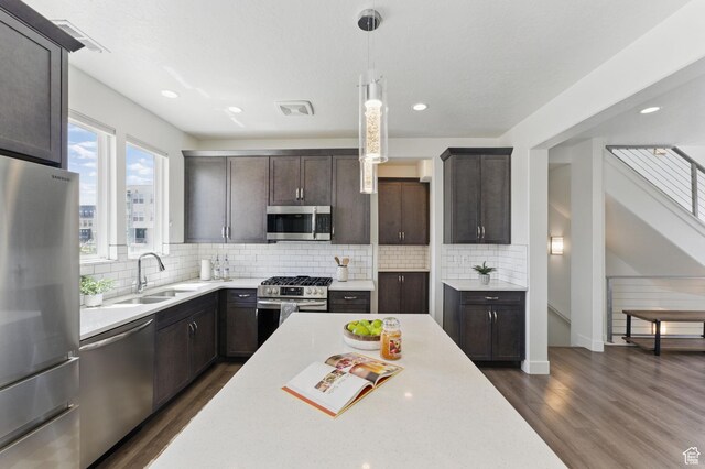 11398 Lake Run Rd, South Jordan, UT 84095 - kitchen featuring appliances with stainless steel finishes, a sink, dark wood-style floors, light countertops, and recessed lighting