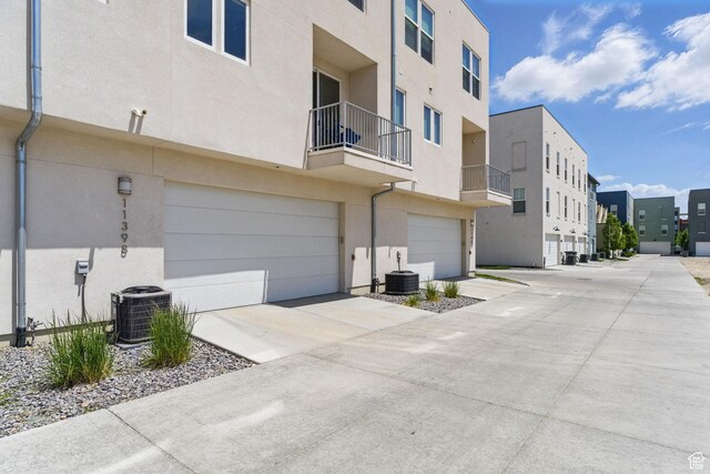 11398 Lake Run Rd, South Jordan, UT 84095 - view of building exterior with central AC, a residential view, an attached garage, and concrete driveway