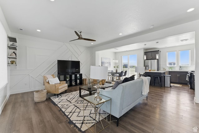 11398 Lake Run Rd, South Jordan, UT 84095 - living area featuring dark wood-style flooring, healthy amount of natural light, ceiling fan, recessed lighting, and a decorative wall