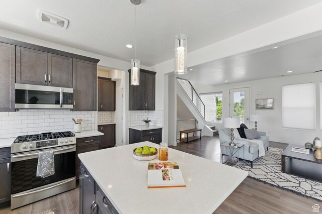 11398 Lake Run Rd, South Jordan, UT 84095 - kitchen with appliances with stainless steel finishes, light countertops, wood finished floors, dark brown cabinetry, and recessed lighting