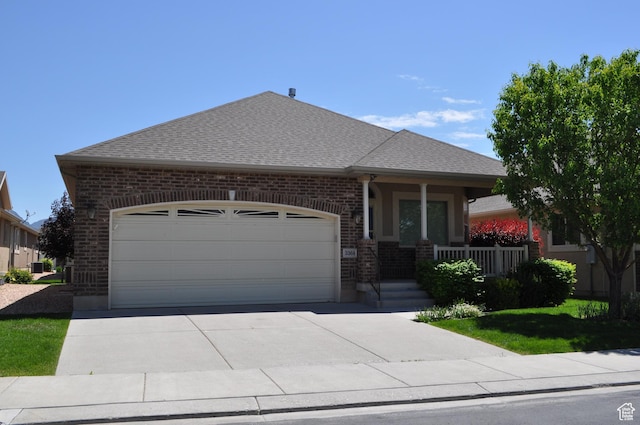 3368 N 700 E, Lehi, UT 84043 - view of front of home with brick siding, a garage, concrete driveway, a shingled roof, and covered porch