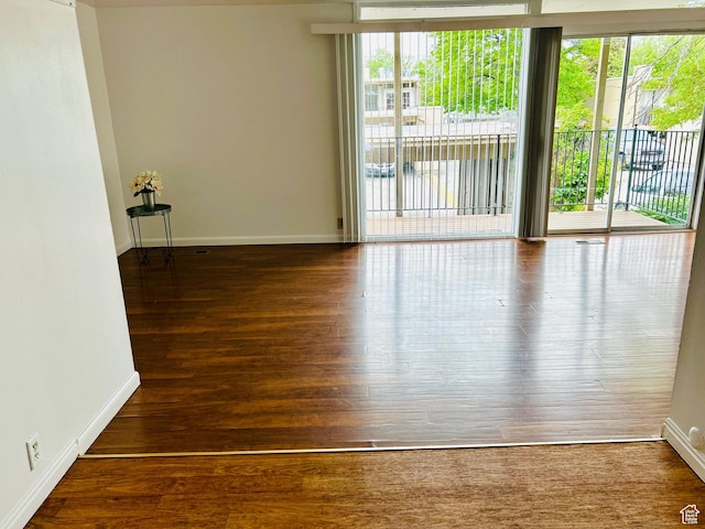 4419 S Rosehaven Ct Unit A, West Valley City, UT 84120 - empty room featuring healthy amount of natural light, baseboards, and wood finished floors