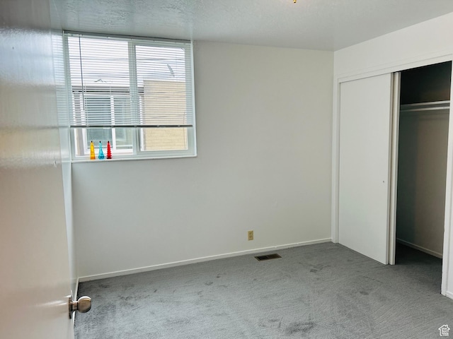 4419 S Rosehaven Ct Unit A, West Valley City, UT 84120 - unfurnished bedroom with carpet floors, baseboards, and a closet