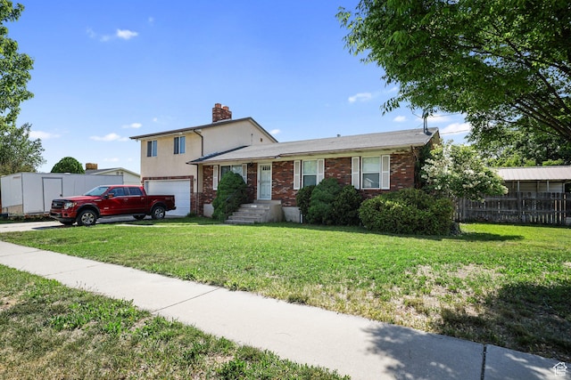 621 N 100 W, American Fork, UT 84003 - tri-level home featuring a chimney, a garage, brick siding, and driveway