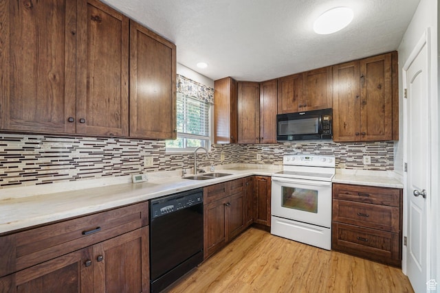 621 N 100 W, American Fork, UT 84003 - kitchen featuring black appliances, a sink, tasteful backsplash, light wood-style flooring, and a textured ceiling