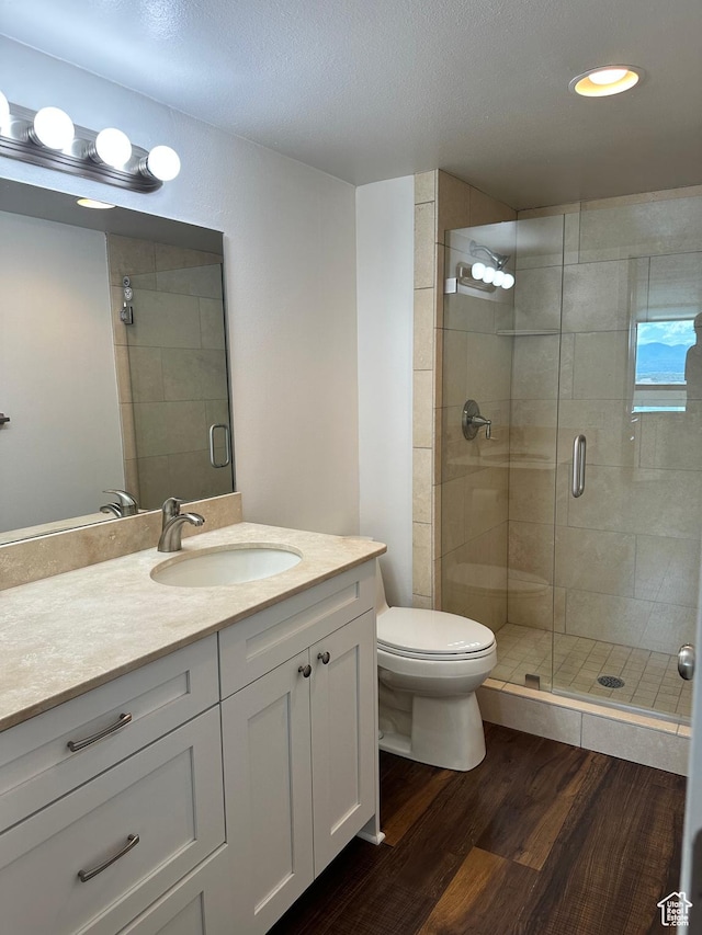 241 N Vine St E Unit 207W, Salt Lake City, UT 84103 - full bathroom featuring wood finished floors, vanity, a shower stall, and a textured ceiling
