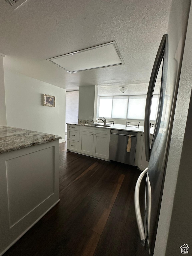 241 N Vine St E Unit 207W, Salt Lake City, UT 84103 - kitchen featuring appliances with stainless steel finishes, dark wood-type flooring, a sink, light stone counters, and a textured ceiling
