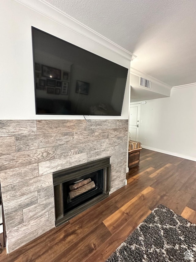 241 N Vine St E Unit 207W, Salt Lake City, UT 84103 - detailed view of crown molding, wood finished floors, a stone fireplace, baseboards, and a textured ceiling