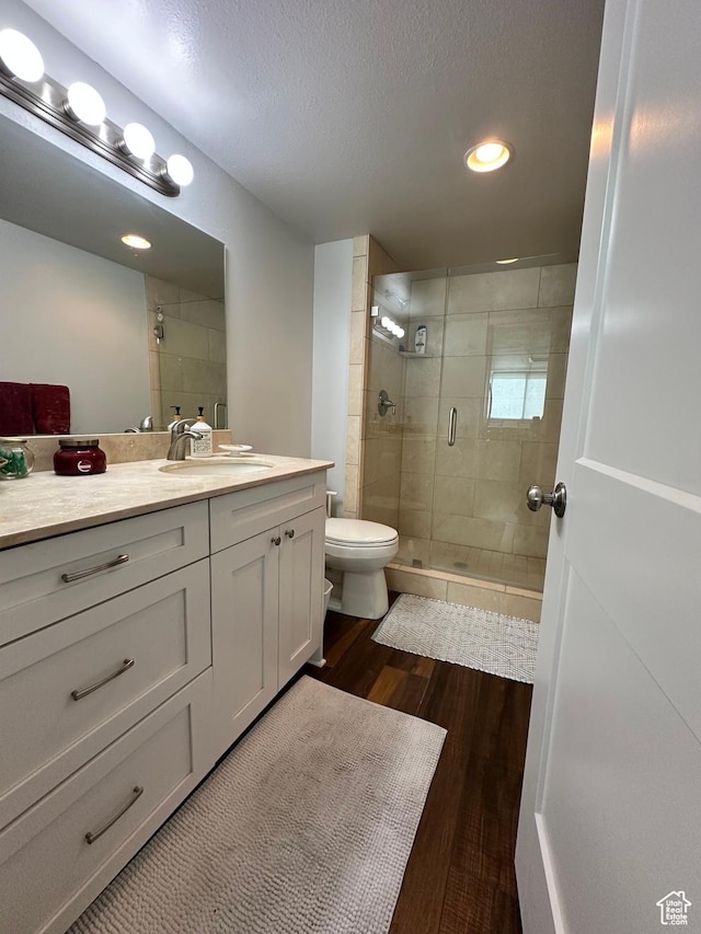 241 N Vine St E Unit 207W, Salt Lake City, UT 84103 - bathroom with a shower stall, toilet, vanity, wood finished floors, and recessed lighting