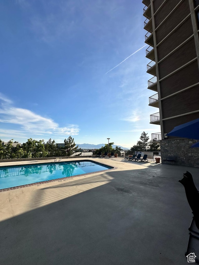 241 N Vine St E Unit 207W, Salt Lake City, UT 84103 - community pool featuring a patio and a mountain view