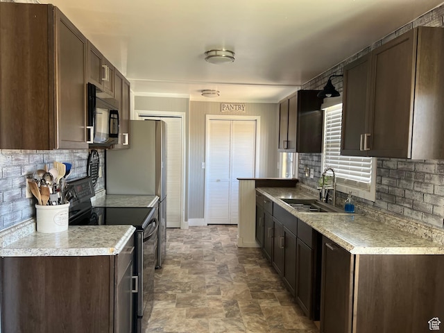 310 E Ashley Way S, Manila, UT 84046 - kitchen with black appliances, a sink, dark brown cabinetry, decorative backsplash, and stone finish floors