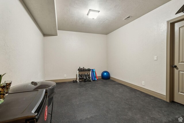1744 E Burning Oak Dr, Draper, UT 84020 - workout area featuring a textured ceiling and baseboards