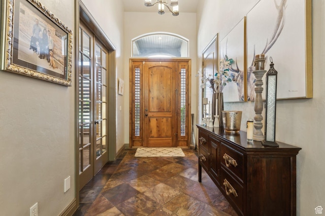 1744 E Burning Oak Dr, Draper, UT 84020 - entrance foyer featuring dark stone finish floors, a chandelier, and french doors