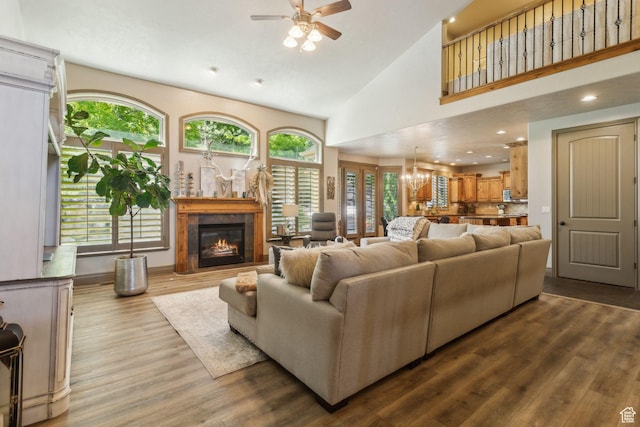 1744 E Burning Oak Dr, Draper, UT 84020 - living room featuring ceiling fan, a glass covered fireplace, healthy amount of natural light, wood finished floors, and high vaulted ceiling