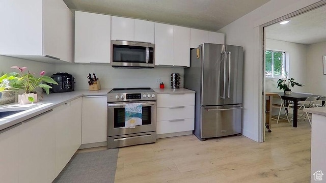358 E 100 N, Provo, UT 84606 - kitchen featuring appliances with stainless steel finishes, white cabinetry, light countertops, and light wood-type flooring