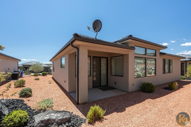 1060 W Jonathon Dr, Washington, UT 84780 - back of property featuring a patio area, stucco siding, and central AC unit