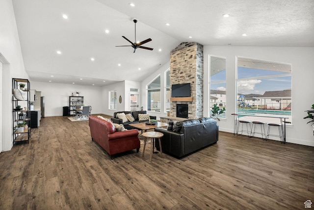 200 W 1200 S Unit 52, Tremonton, UT 84337 - living area featuring dark wood-type flooring, a fireplace, a ceiling fan, healthy amount of natural light, and high vaulted ceiling