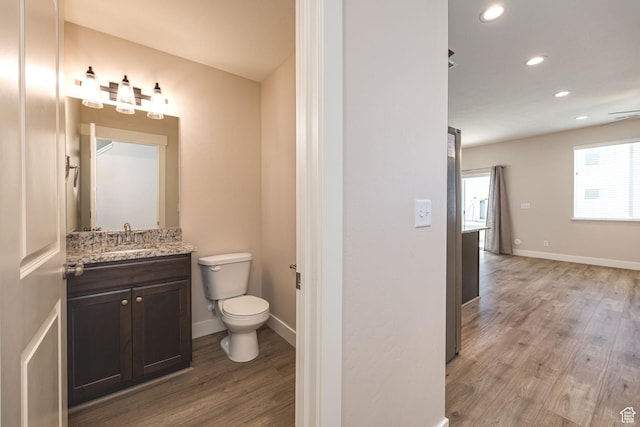 200 W 1200 S Unit 52, Tremonton, UT 84337 - bathroom with wood finished floors, toilet, vanity, recessed lighting, and baseboards