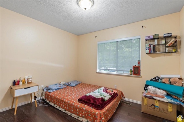 7638 S Redwood Rd Unit 17, West Jordan, UT 84084 - bedroom with wood finished floors, baseboards, and a textured ceiling